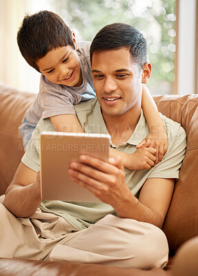 Buy stock photo Happy father, kid and hug with tablet in home for online games, reading ebook story and elearning multimedia. Man, dad and boy child watch cartoon, movies or digital technology on sofa in living room