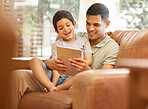Family, child and father on tablet and sofa in e learning, funny games and school or online education with love and support. Happy dad, man and kid on couch, home or living room on digital technology
