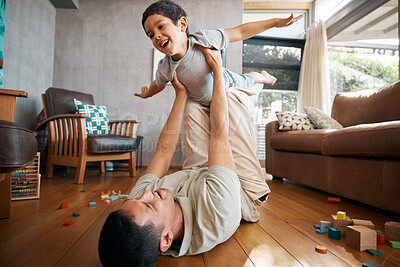 Buy stock photo Child, father and airplane games in home on living room floor for support, happy together and crazy fun. Dad, boy and excited kid flying for freedom, fantasy and playing with balance, care and energy