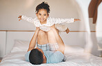 Kid, father and airplane games on bed for support or relax at home for crazy fun. Portrait, dad and happy girl child excited to fly in bedroom for freedom, fantasy and balance of play, care or energy