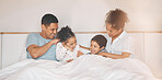 Happy, tickle and relax with family in bedroom for playful, morning and love. Care, support and wake up with parents and children laughing in bed at home for weekend, positive and resting together