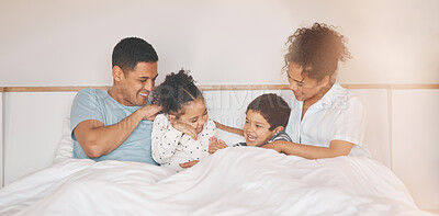 Buy stock photo Happy, tickle and relax with family in bedroom for playful, morning and love. Care, support and wake up with parents and children laughing in bed at home for weekend, positive and resting together