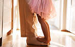 Dance, learning and feet of father and daughter for ballet, support and love. Music, help and youth with closeup of man and girl dancing in family home for teaching, creative and princess together