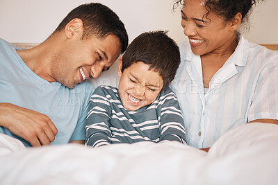 Buy stock photo Happy, tickle and funny with family in bedroom for playful, morning and love. Care, support and wake up with parents and boy child laughing in bed at home for weekend, positive and relax together