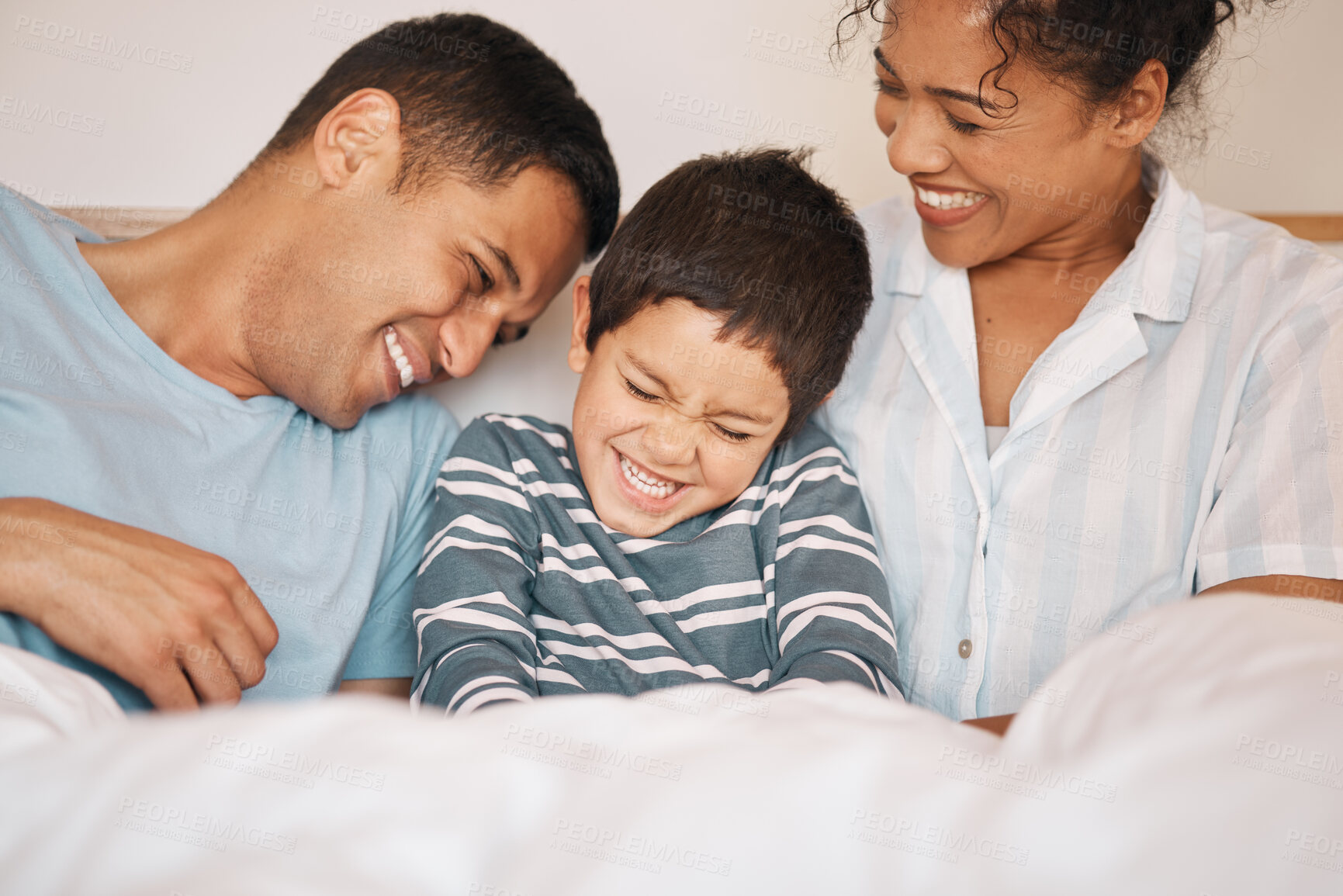 Buy stock photo Happy, tickle and funny with family in bedroom for playful, morning and love. Care, support and wake up with parents and boy child laughing in bed at home for weekend, positive and relax together