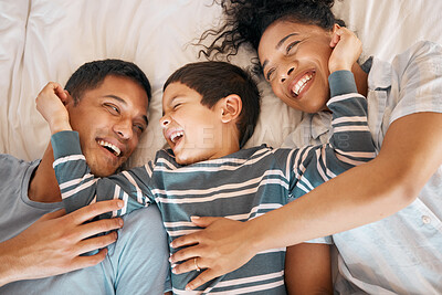 Buy stock photo Happy, funny and playful with family in bedroom for relax, morning and love. Care, support and wake up with parents and child from above in bed at home for weekend, positive or smile together