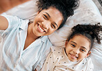 Top view, selfie and mother with girl child on a bed happy, bond and relax at home. Love, profile picture and kid with mom influencer smile for social media, blog or podcast post or bedroom memory