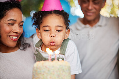 Buy stock photo Girl, birthday party and blow candles with cake, celebration and support with applause, hat and happy in family home. Child, flame and wish with congratulations, food and dessert with gift at event