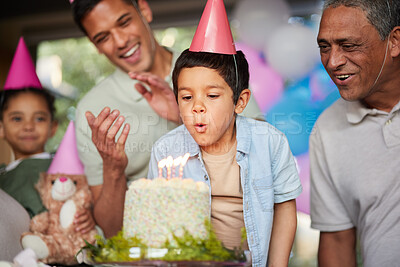 Buy stock photo Boy, birthday party and blow candles with cake, celebration and support with applause, hat and happy in family home. Child, flame and wish with congratulations, food and dessert with gift at event