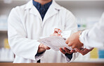 Healthcare, pharmacy and prescription medicine in hand of customer with paper, box or rx medication. Closeup of pharmacist or medical staff with person for pharmaceutical product at retail drugstore