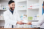Pharmacist, man and smile with customer pills payment in store with healthcare and medical help. Pharmacy, happy and supplements information with a professional with package in pharmaceutical shop