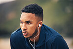 Outdoor, earphones and man with fitness, tired and sweat with workout, training and exhausted. Person, guy and athlete outside, streaming music and exercise with fatigue, listening to audio and rest