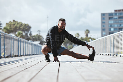 Buy stock photo Exercise, outdoor and man stretching, fitness and workout with warm up, freedom and training with health. Athlete, person or runner with wellness, stretch or sports with practice in a city and energy