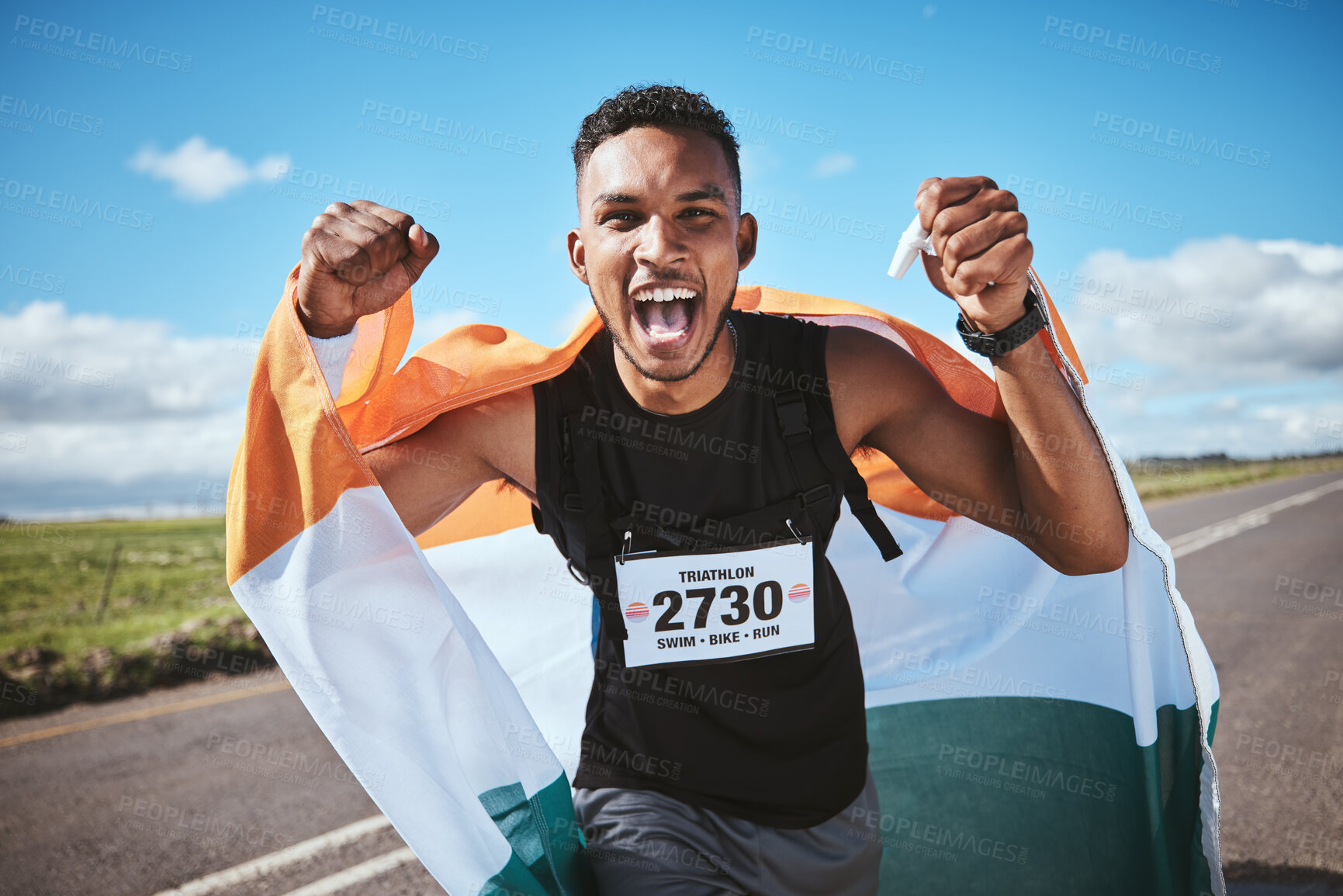 Buy stock photo Portrait, fitness and flag of India with a man runner on a street in nature for motivation or success. Sports, winner and health with a male athlete cheering during cardio or endurance training
