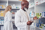 Pharmacy product, clipboard and mature black man reading medicine label, prescription information or search shop shelf. Hospital inventory, box and African healthcare expert check stock checklist