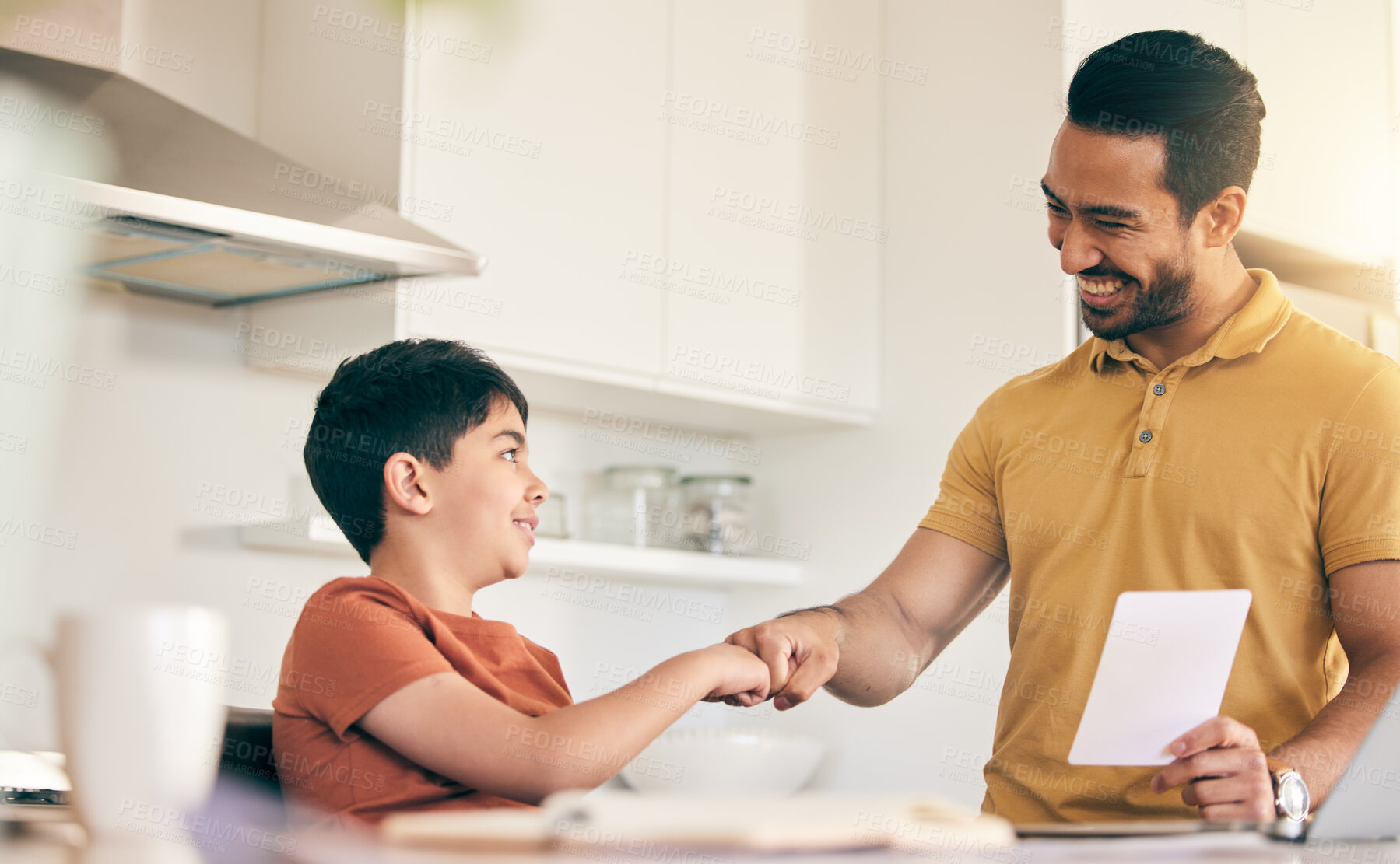 Buy stock photo Fist bump, homework and father with child at their home in celebration of completed studying. Happy, smile and young dad bonding together with his boy kid in the kitchen of modern house or apartment.