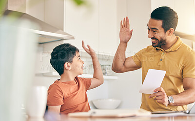 Buy stock photo High five, homework and father with child at their home in celebration of completed studying. Happy, smile and young dad bonding together with his boy kid in the kitchen of modern house or apartment.