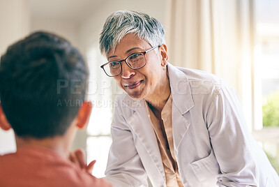 Buy stock photo Mature doctor, smile and woman with child in consultation at hospital, healthcare and wellness. Pediatrician, happy and medical professional with kid in communication, help patient or check at clinic