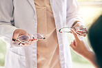 Glasses, choice and hands with optometry, frame and lens decision of a patient at a eye clinic. Wellness, ophthalmologist and customer shopping for vision and prescription eyeglasses with purchase