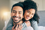 Couple, portrait and hug in bedroom, smile and love with bonding, care and trust in healthy relationship. Interracial, people relax at home and happy, romance and partner with marriage and commitment