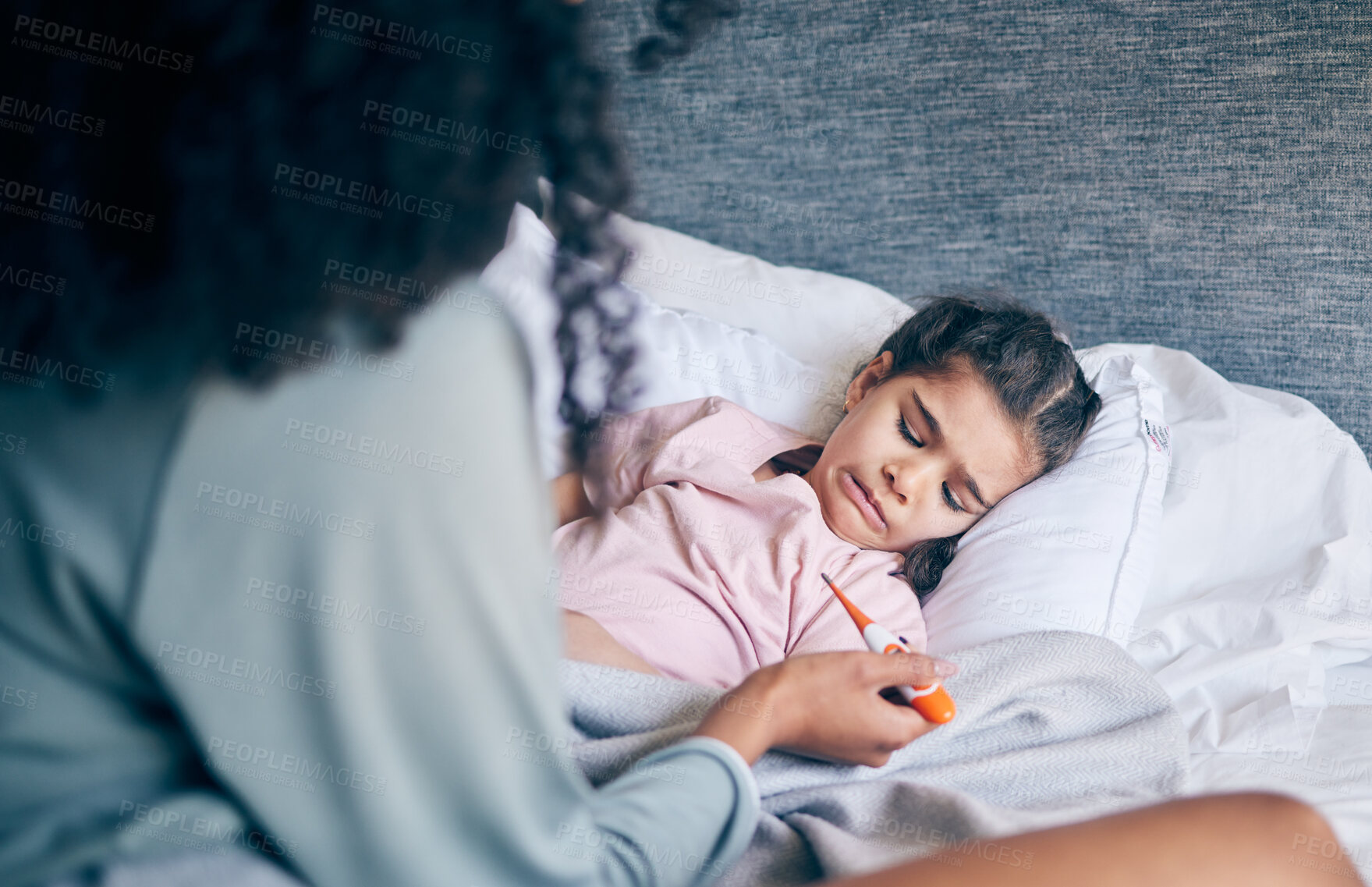 Buy stock photo Mother, thermometer and sick child in bed with illness, virus or infection and caring parent at home. Mom checking kid or little girl with fever, cold or flu in health or medical attention in bedroom