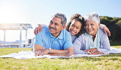 Buy stock photo Grandparents, girl and blanket on grass, relax and smile with hug, love and picnic on family vacation in summer. Senior man, woman and grandchild with embrace, thinking and happy in sunshine on lawn