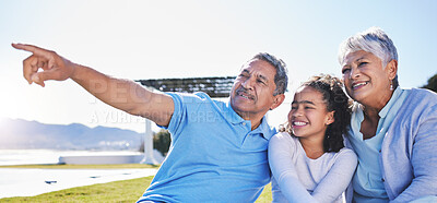 Buy stock photo Happy, talking or grandparents with child in nature bonding to relax with care in retirement on mockup space. Smile, grandmother or senior grandfather pointing with a kid on holiday in summer park