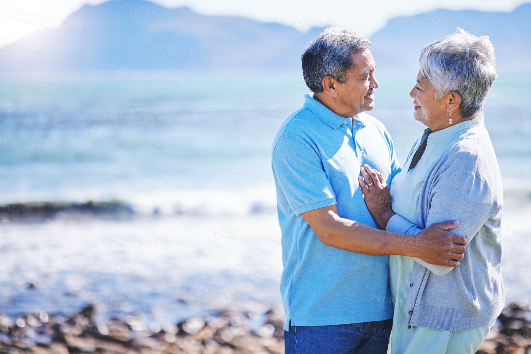 Buy stock photo Love, hug and senior couple at a beach for travel, bond and happy in nature together. Retirement, freedom and elderly man embrace old woman at sea, trust or care on traveling ocean trip in Mexico