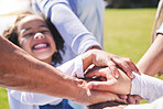 Hands, stack and happy family with child for playing on field with support, bonding and love in a park together. Solidarity, excited and kid with parents for outdoor freedom with care, trust or hope