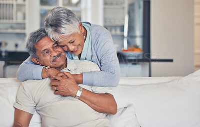 Buy stock photo Senior couple, hug and love in care, support or embrace and bonding on living room sofa together at home. Happy mature man and woman smile in happiness for romance, weekend break or relax in house