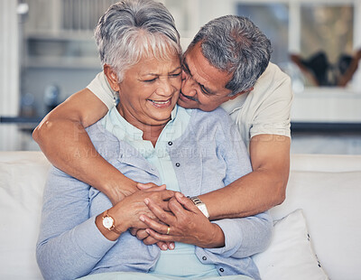 Buy stock photo Love, hug and a senior couple on a sofa in the living room of their home together during retirement. Support, relax and a elderly man embracing his pensioner wife in a house for relationship bonding