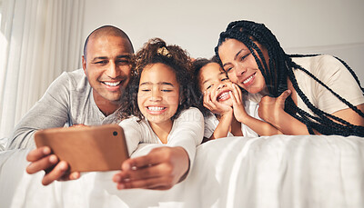 Buy stock photo Happy, bed and selfie of family at home in morning for social media, memory and love. African woman, man and kids lying in bedroom for profile picture, vacation and relax with mother and father