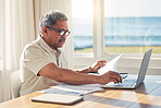 Senior man, laptop and documents in budget planning, schedule payment or checking bills at home. Mature male person working on computer, paperwork or expenses in finance, insurance or retirement plan