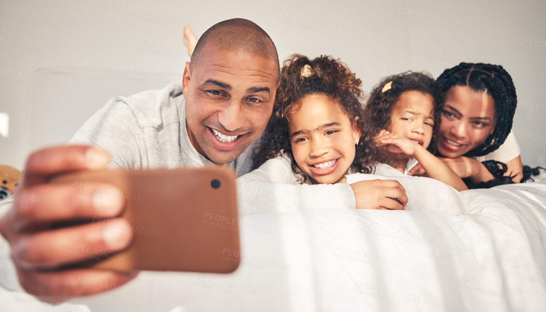 Buy stock photo Home, bed and father take selfie of happy family in morning for social media, memory and love. African woman, man and kids lying on bedroom for profile picture, vacation and relax on fun holiday