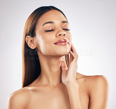 Buy stock photo Woman, touching face and natural beauty in a studio, wellness and dermatology isolated on white background. Anti aging, treatment and skincare with glow, makeup and healthy skin with cosmetics shine