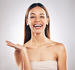 Portrait, woman and hand for beauty, skincare or advertising offer, space or mockup for marketing on white background in studio. Makeup, deal and smile on face for choice, cosmetics or branding