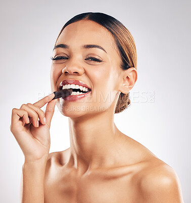 Buy stock photo Chocolate, smile and portrait of woman in studio with diet, detox or sweet, unhealthy and snack on white background. Happy, face and female model with sugar, candy bar or eating cocoa treats isolated