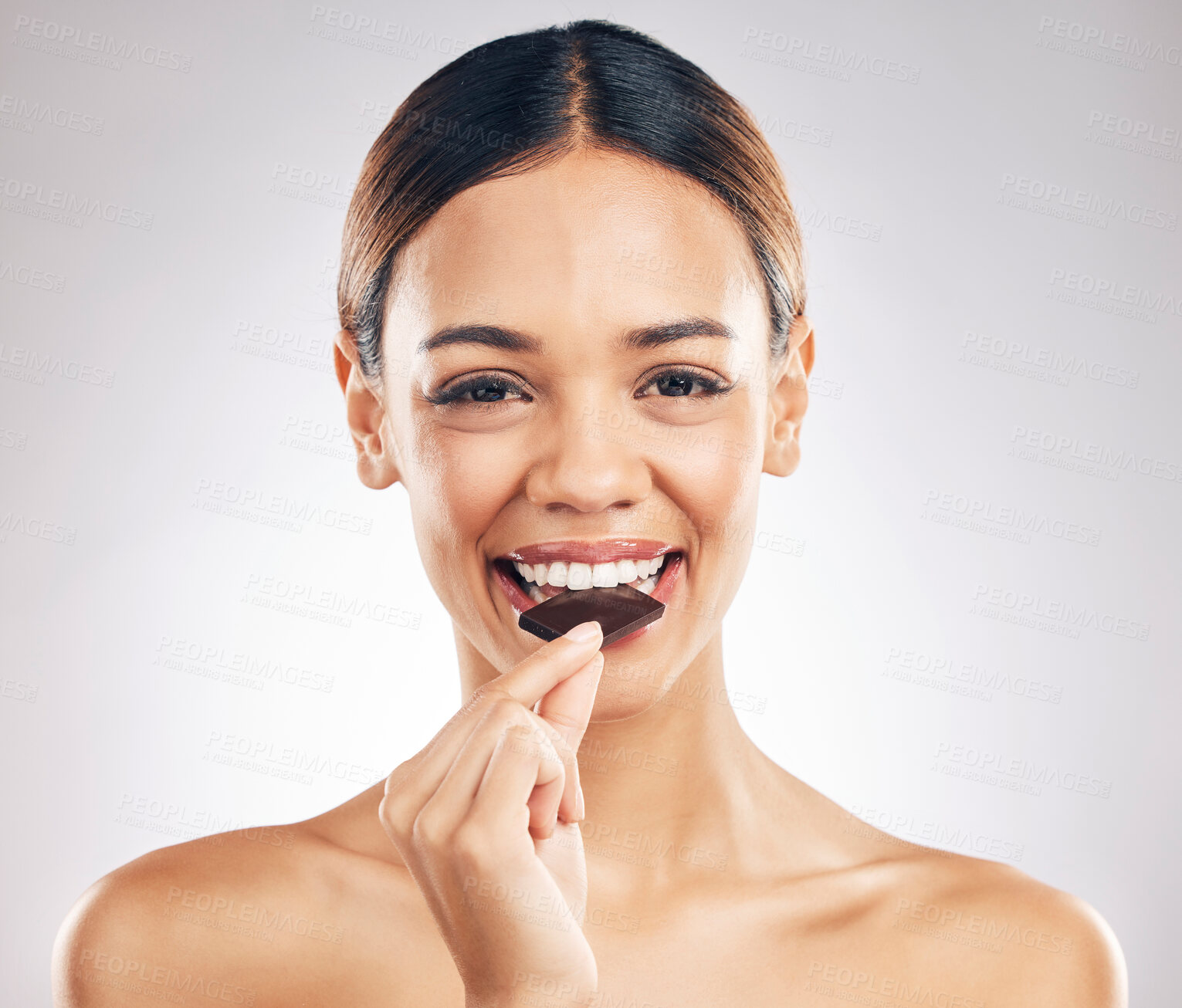 Buy stock photo Woman, eating chocolate and portrait for skincare, beauty and wellness, health or diet on white background. Young person or face of model with cacao or candy for skin care and dermatology in studio