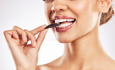 Buy stock photo Woman, chocolate and mouth for eating, studio and healthy with nutrition, diet and bite by white background. Girl, model and cacao for wellness, detox or cosmetics with detox, teeth or antioxidants