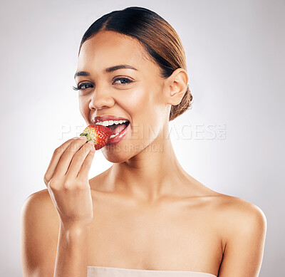 Buy stock photo Woman, eating strawberry and beauty portrait, skincare or eco friendly product, color choice and dermatology in studio. Person, red fruit and vegan makeup, lipstick or cosmetics on a white background
