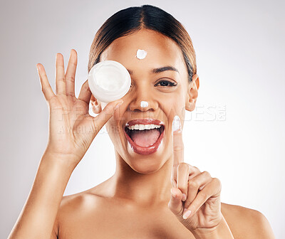 Buy stock photo Woman, cream container and hands for eye skincare, beauty or cosmetics application on a white background. Excited person in happy portrait for collagen, moisturizer and dermatology health in studio