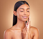 Woman, eyes closed and face for natural skincare, aesthetic glow or smile for clean dermatology on brown background. Happy indian model, beauty or shine in studio for self care of soft facial results
