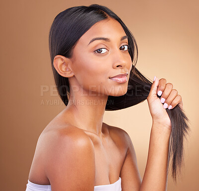 Buy stock photo Portrait, woman and growth of hair in studio for keratin treatment, shampoo cosmetics and clean dermatology on brown background. Indian model, natural beauty and care for strong hairstyle with shine