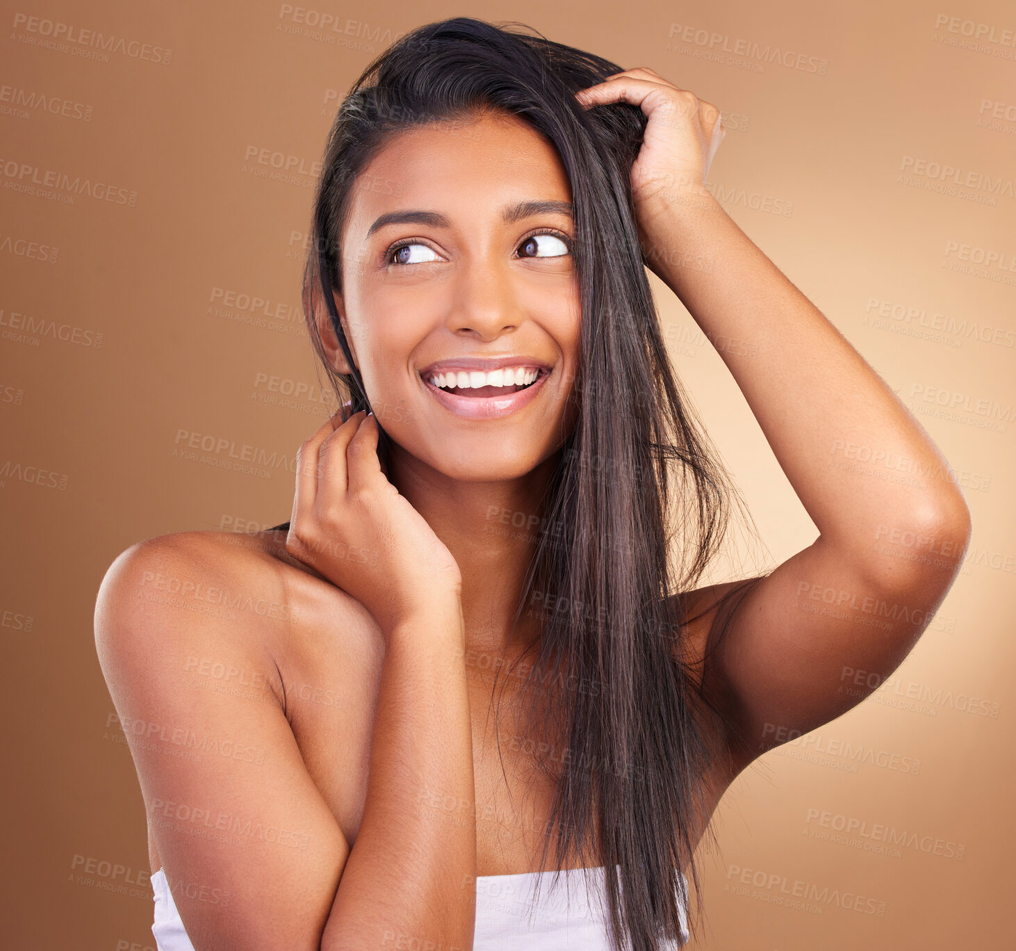 Buy stock photo Beauty, smile and woman in studio for hair, growth or texture and shine against a brown background space. Haircare, cosmetics and face of female model happy for shampoo, mask or volume and results 