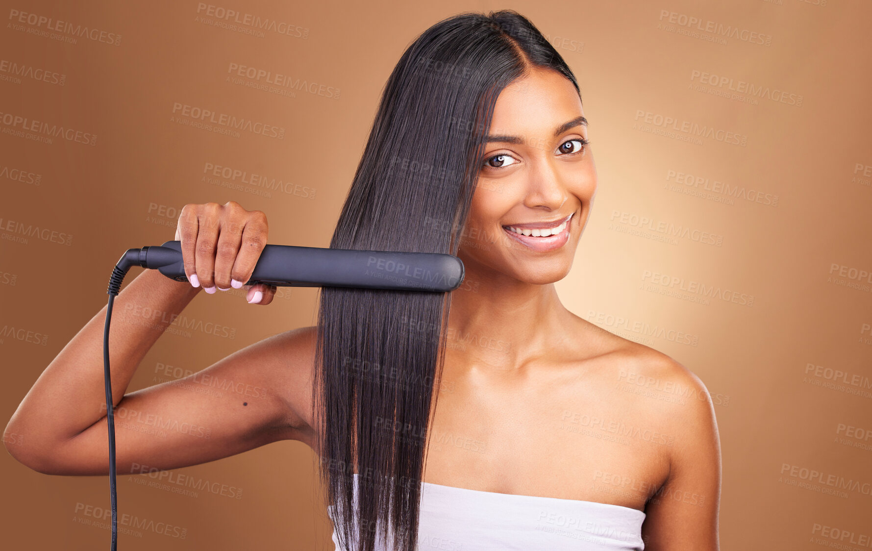 Buy stock photo Straightener, hair care and woman portrait with smile and happy from Brazilian treatment in studio. Salon, natural beauty and hairdresser tool for healthy hairstyle and wellness with brown background