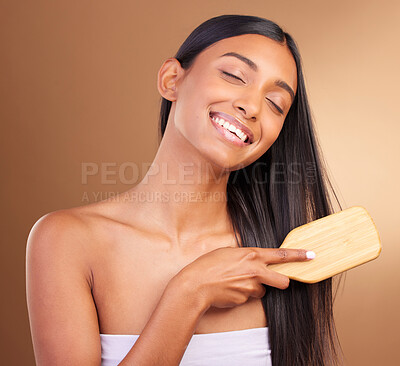 Buy stock photo Happy, hair care and woman with a brush, shine and texture on a brown studio background. Person, girl and model with style, luxury or shampoo with natural beauty, comb or cosmetics with shine or glow