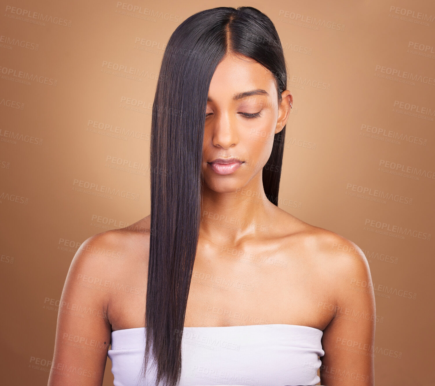 Buy stock photo Beauty, hair and keratin with face of woman in studio for cosmetics, salon treatment and texture. Shampoo, health and growth with Indian model on brown background for glamour, shine and hairstyle