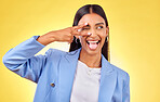 Peace sign, funny and woman with togue out and fashion with emoji hand sign in studio. Yellow background, female person smile and v gesture with freedom, trendy style and worker with confidence