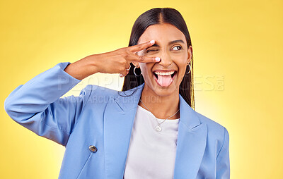 Buy stock photo Peace sign, funny and woman with tongue out and fashion with emoji hand gesture in studio. Yellow background, female person smile and v with freedom, trendy style and worker with happy confidence
