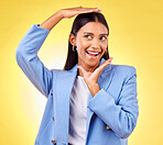 Happy, business and hands of woman frame face in studio yellow background for creative perspective or unique thinking. Indian model, hand and entrepreneur with idea for corporate startup in Mumbai 